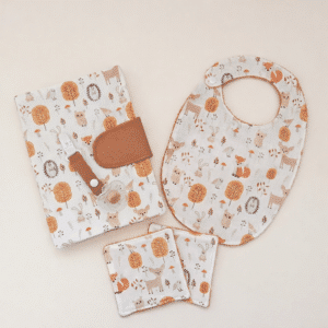 Ensemble bébé Explorateur en herbe comprenant une pochette à langer, un bavoir et des lingettes en coton bio motif forêt.
