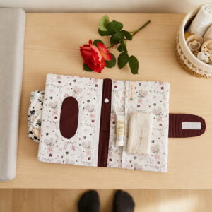 Intérieur de la pochette bébé avec compartiments pour couches, lingettes et attache-tétine.